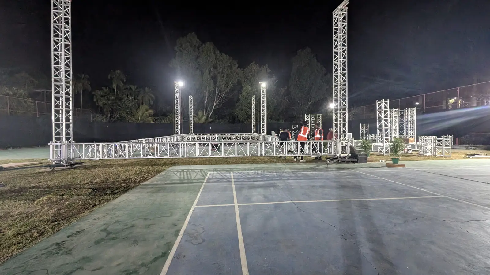 Crew building truss at night