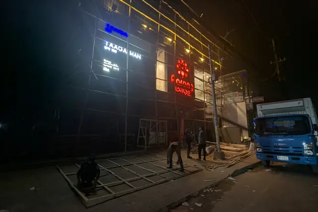 Illuminated storefront branding at night